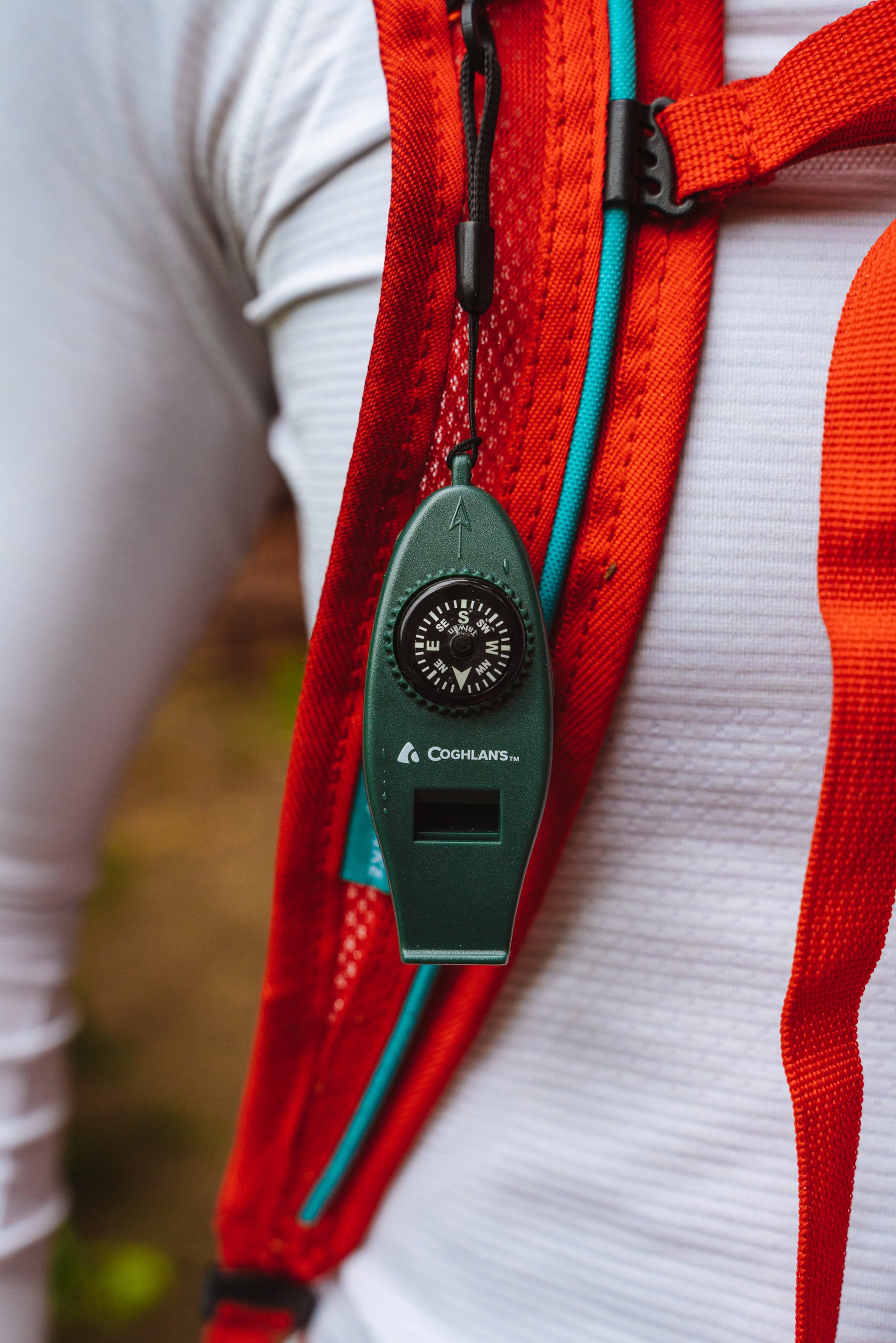 Hiker with Coghlan's Six Function Whistle attached to their backpack