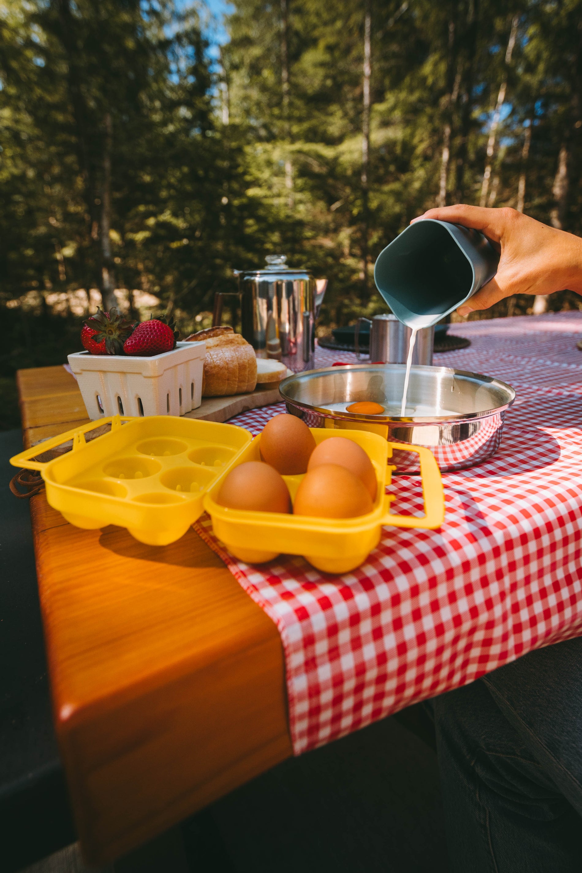 whisking eggs and milk into a pot