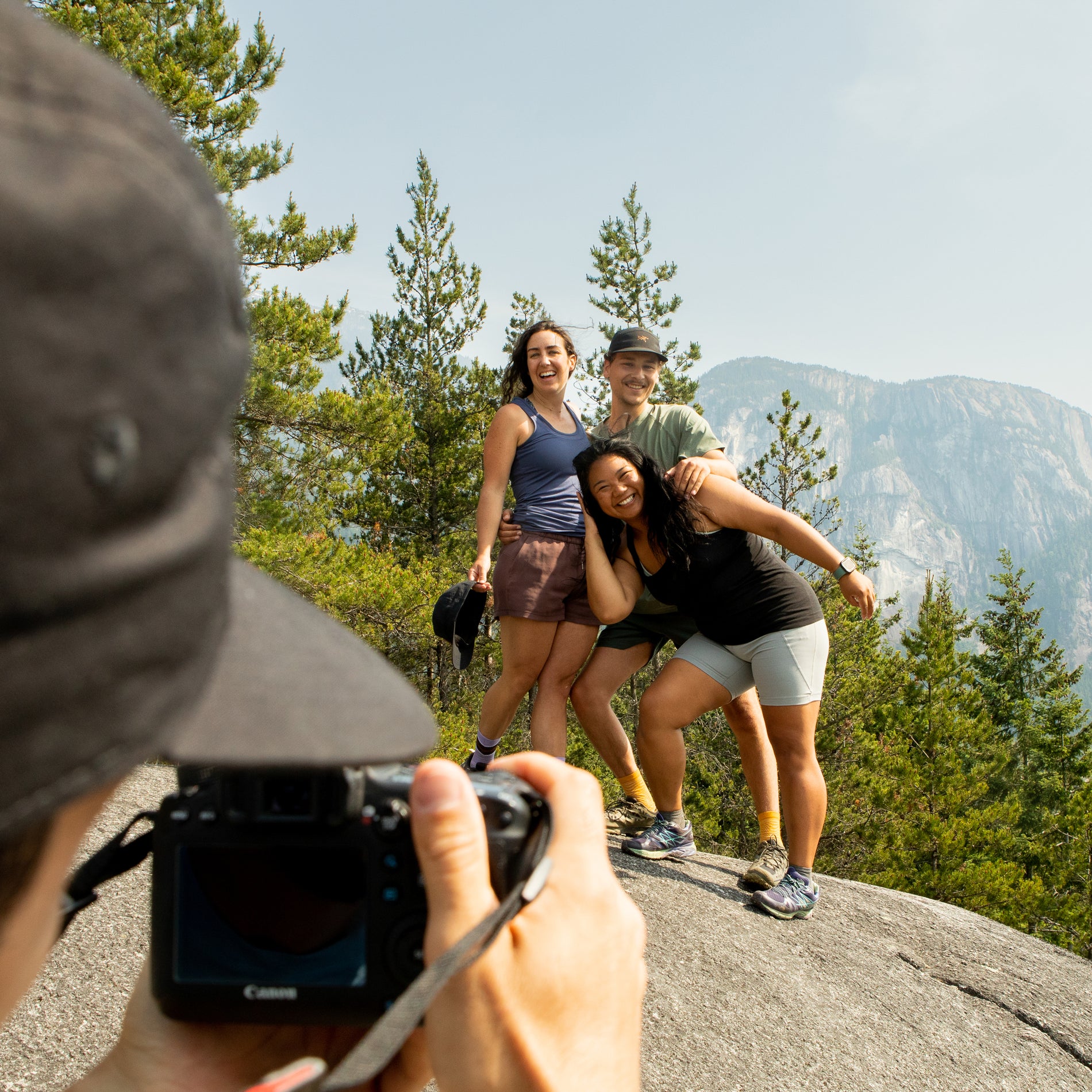 group of friends taking a photo on a cliff