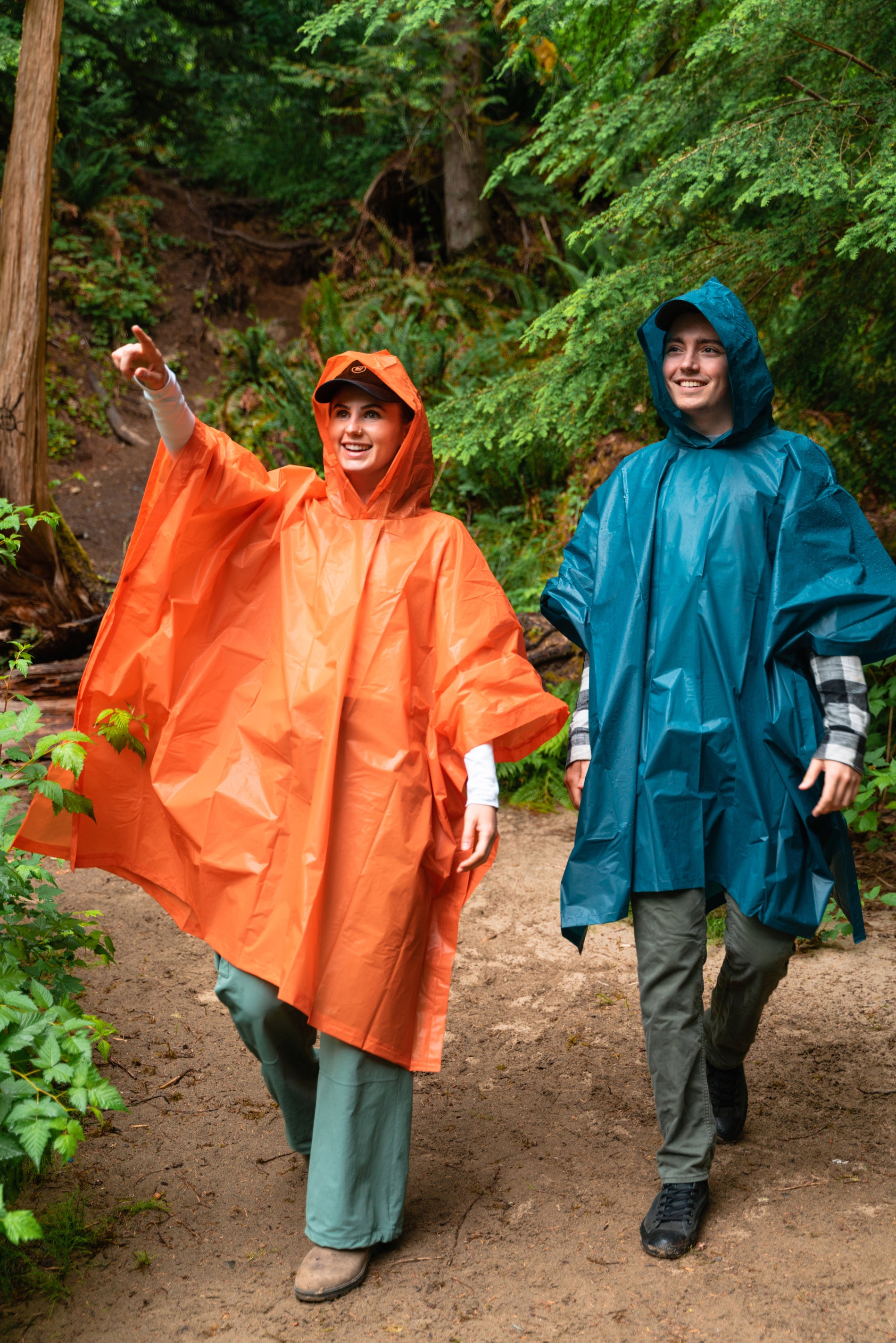 two people hiking in rain ponchos
